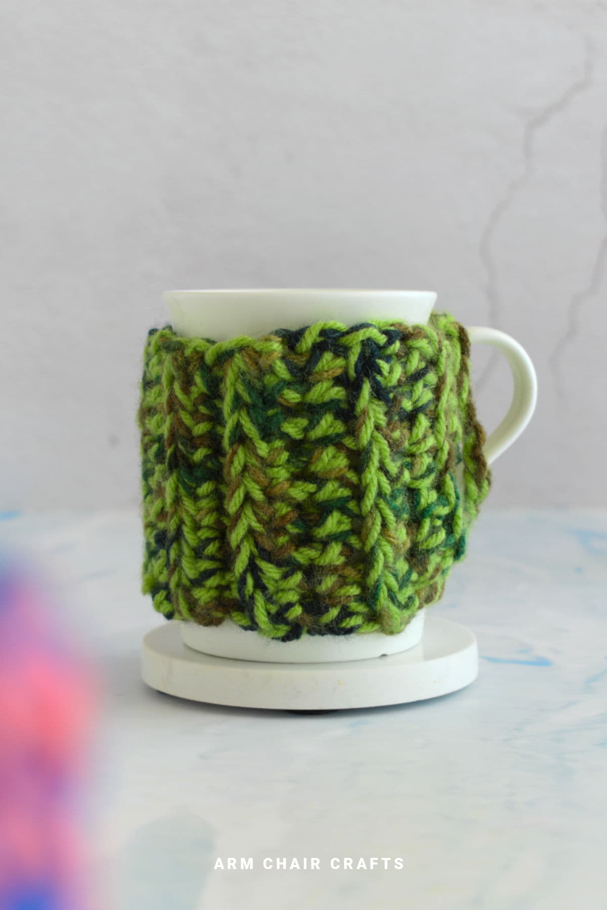 Crochet mug cozy on a mug.