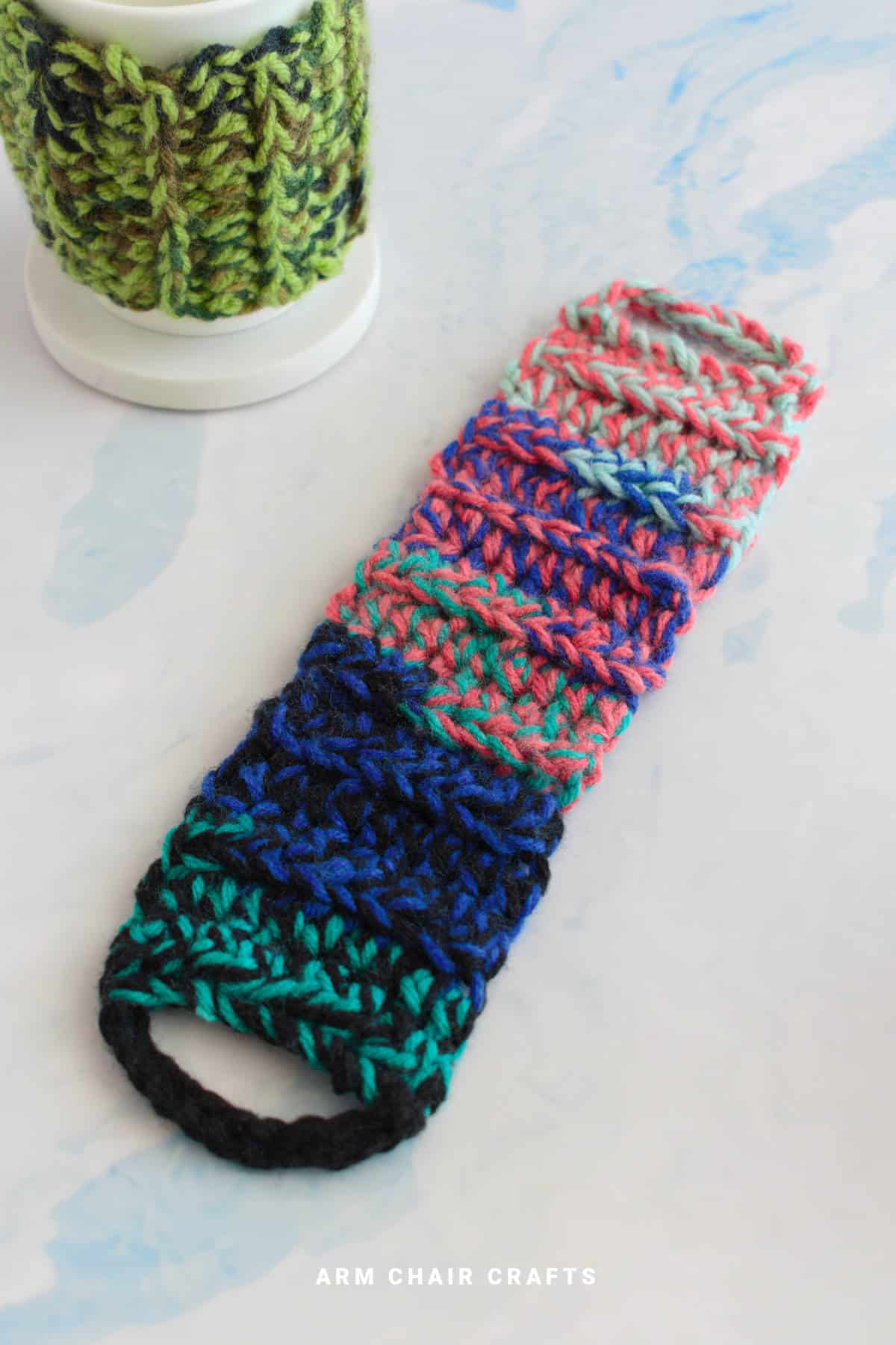 Close up image of a crochet mug cozy.