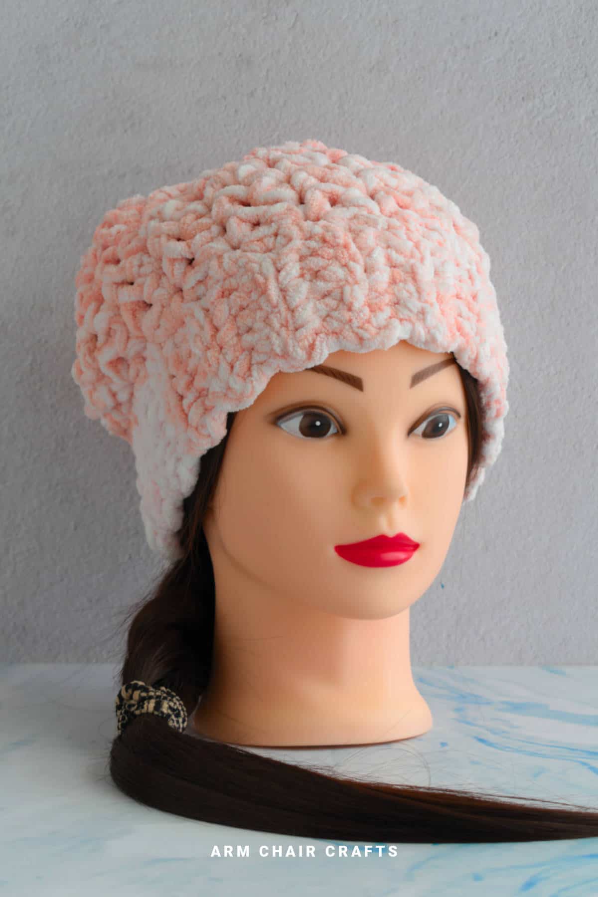 Crochet beanie on a mannequin.