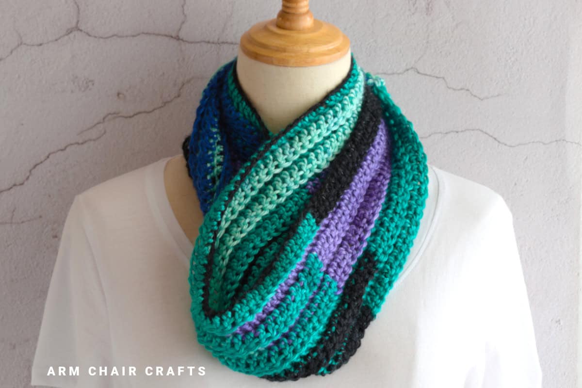 Close up image of a crochet infinity scarf.