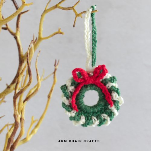 Close up image of a mini crochet wreath.