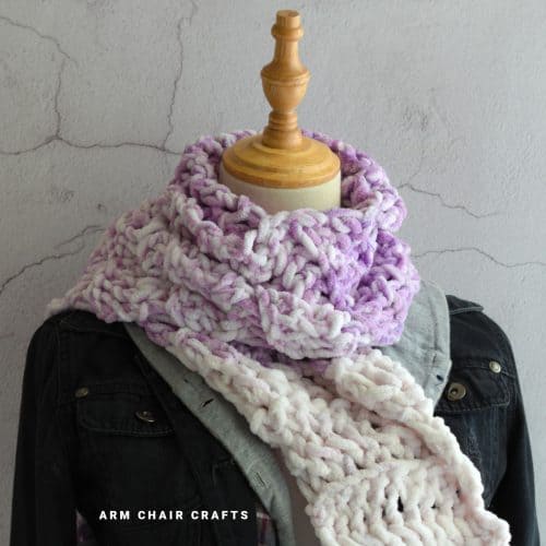 Close up image of a purple crochet scarf.