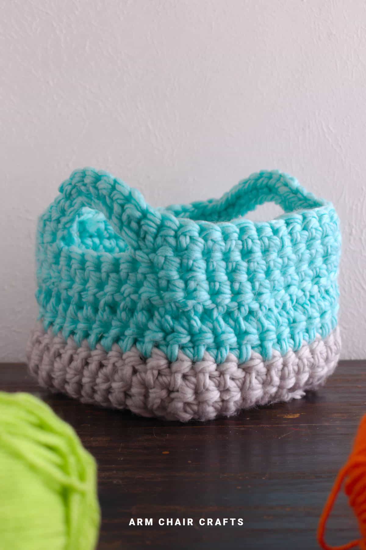 Crochet basket with handles.
