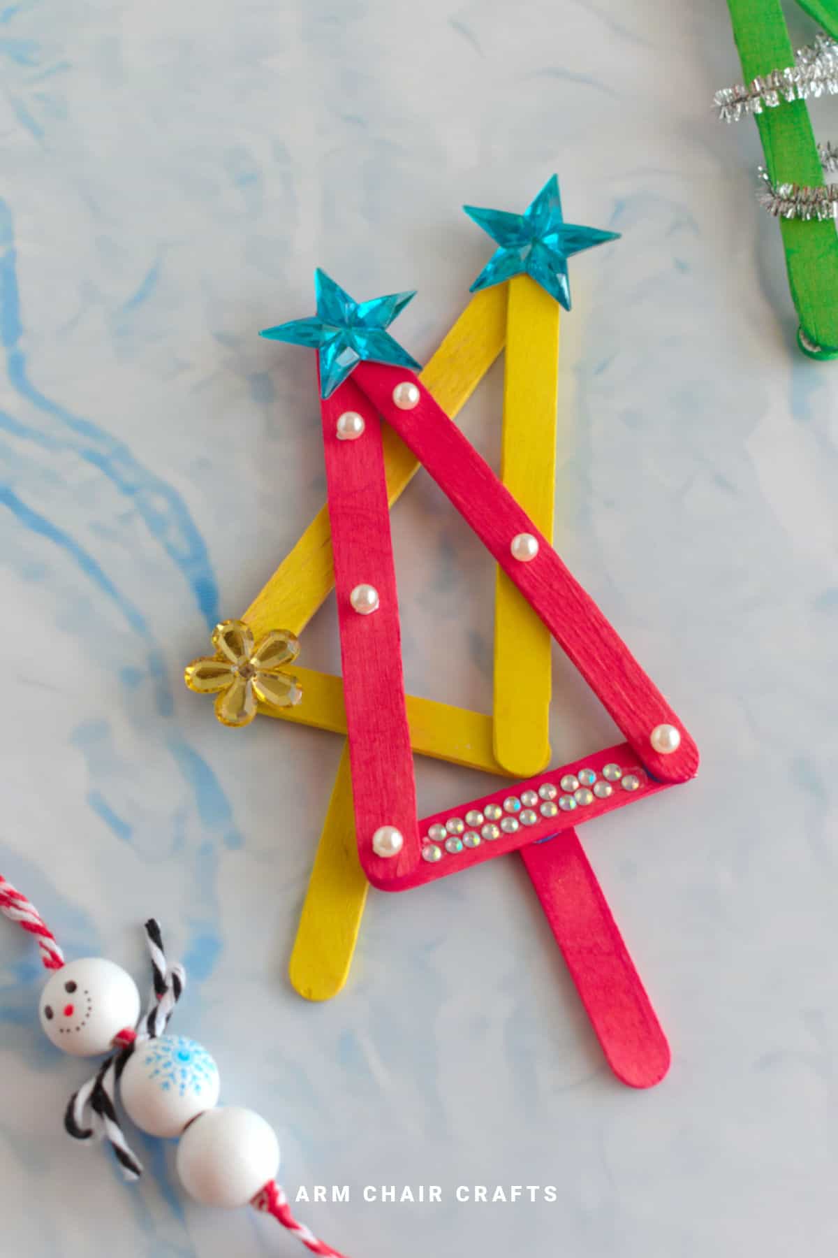 Close up image of popsicle Christmas tree ornaments.