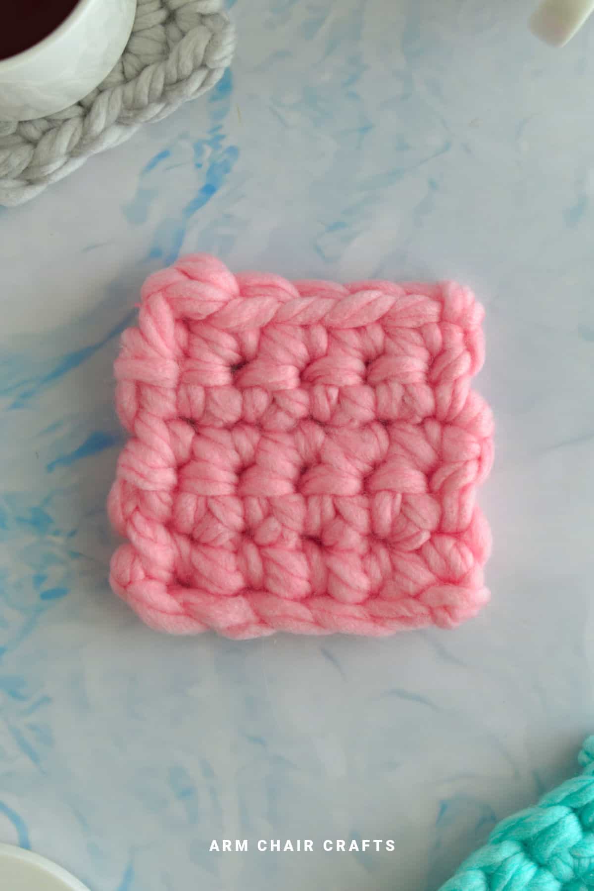 Pink crochet coaster.