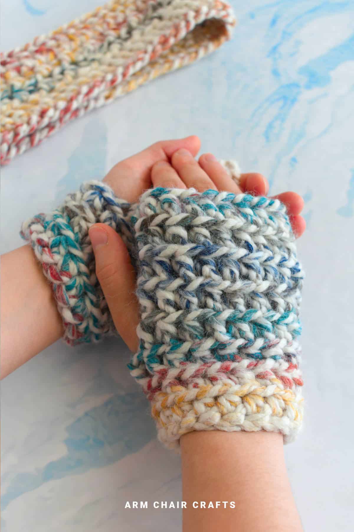 Close up image of chunky crochet fingerless gloves.