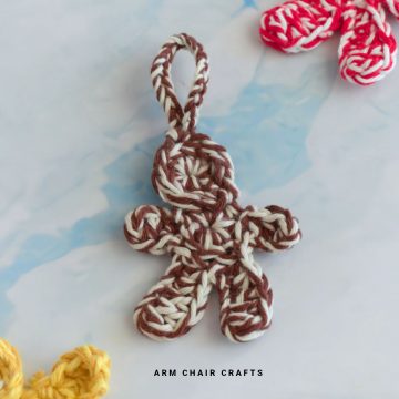 Close up image of a crochet gingerbread man.