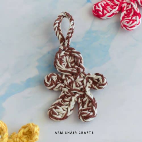 Close up image of a crochet gingerbread man.