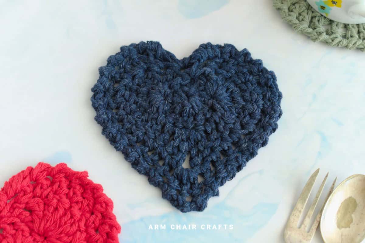 Close up image of a blue crochet coaster.