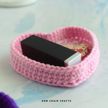 Close up image of a crochet heart trinket box.