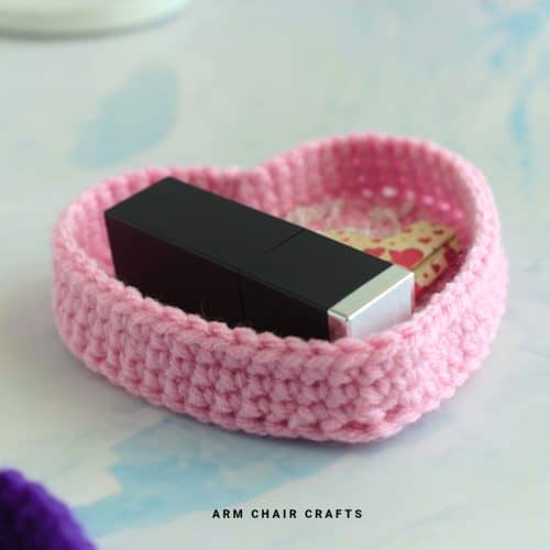 Close up image of a crochet heart trinket box.