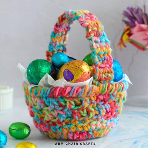 Close up image of a crochet basket with handle.