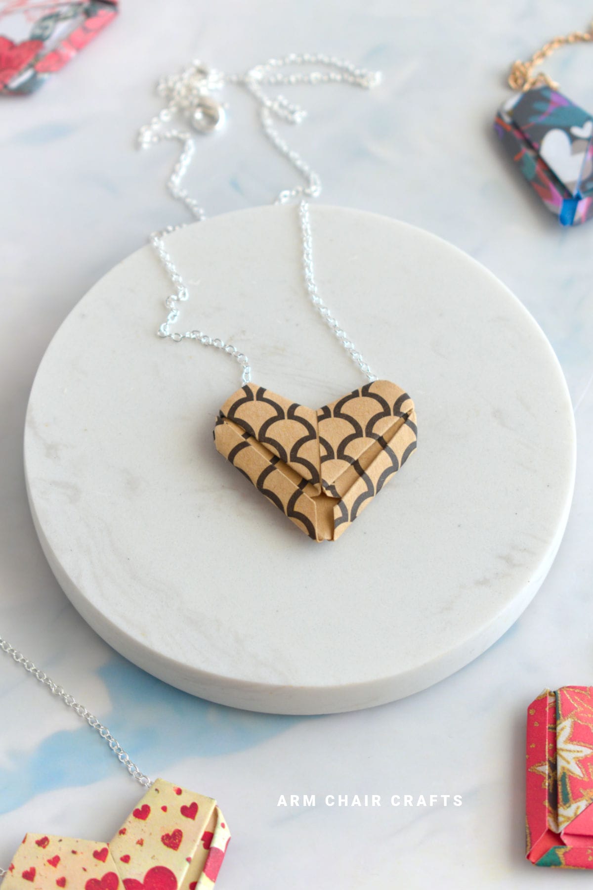 Beige and black paper heart necklace.