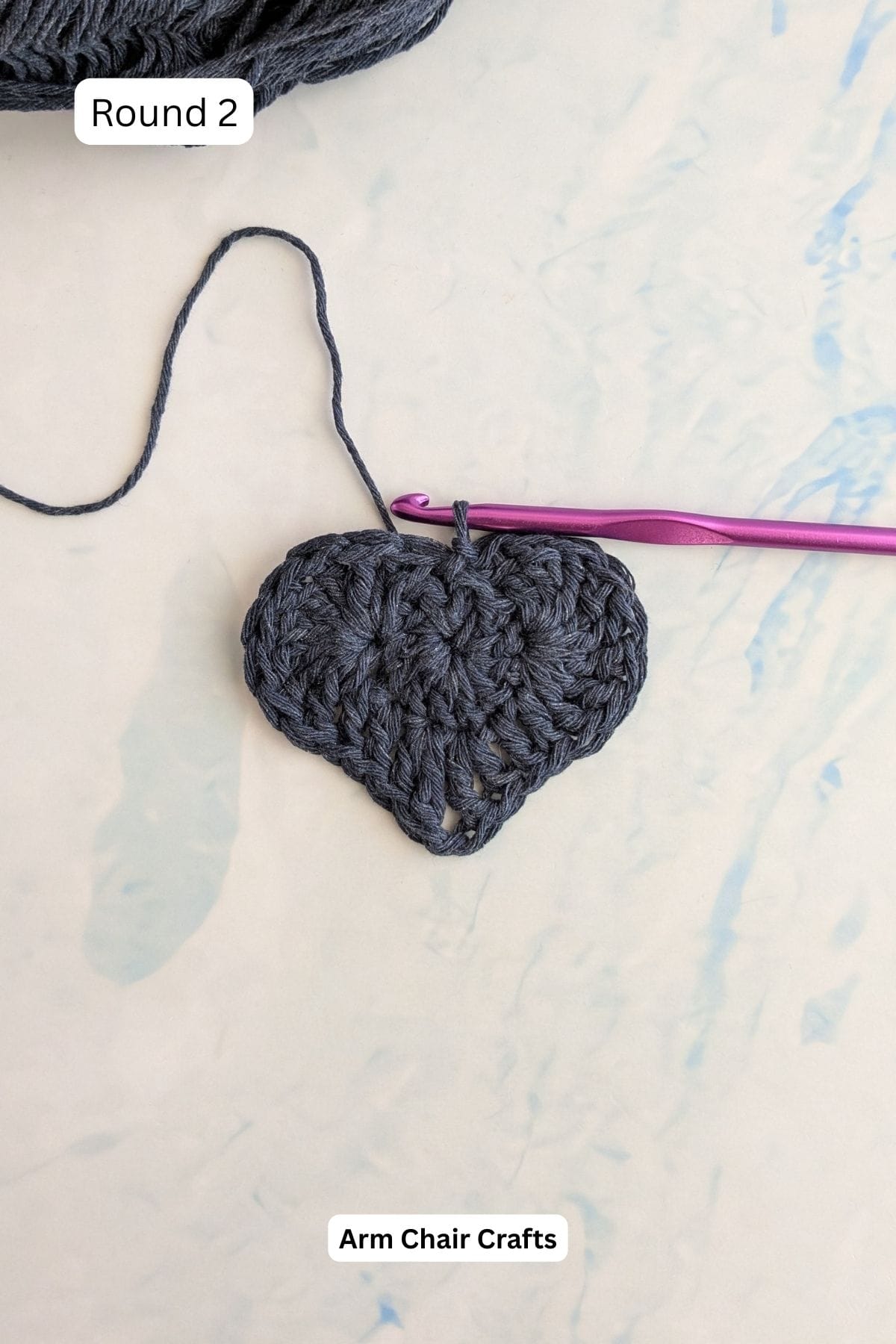 Process of making a crochet heart coaster.