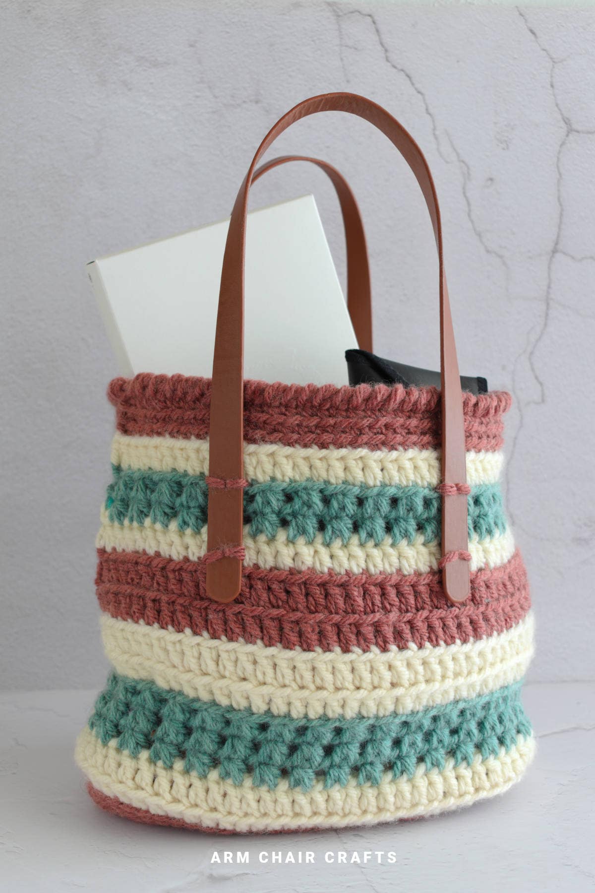 Crochet tote bag with handles.