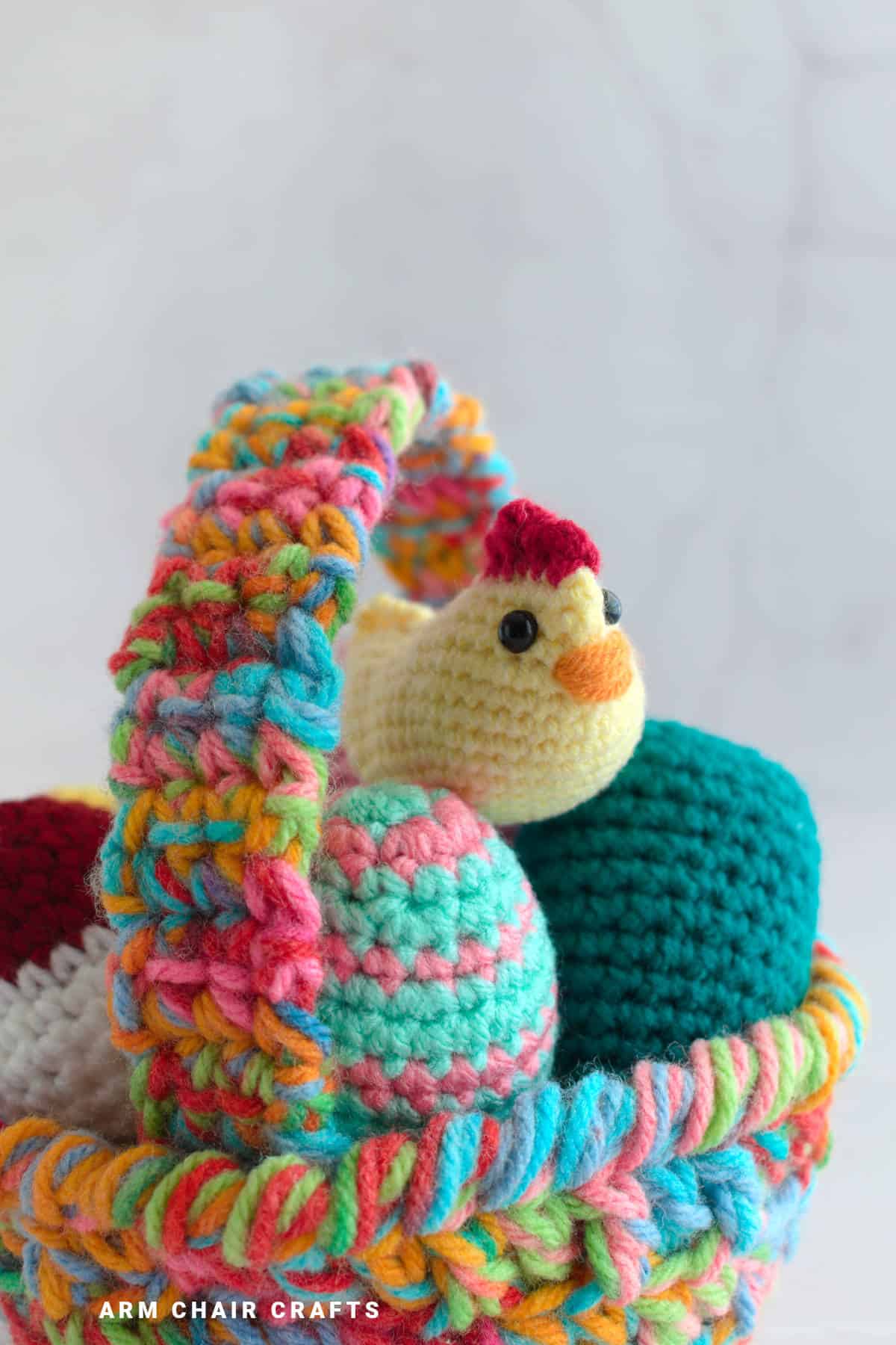 Close up image of an amigurumi chicken in a basket.