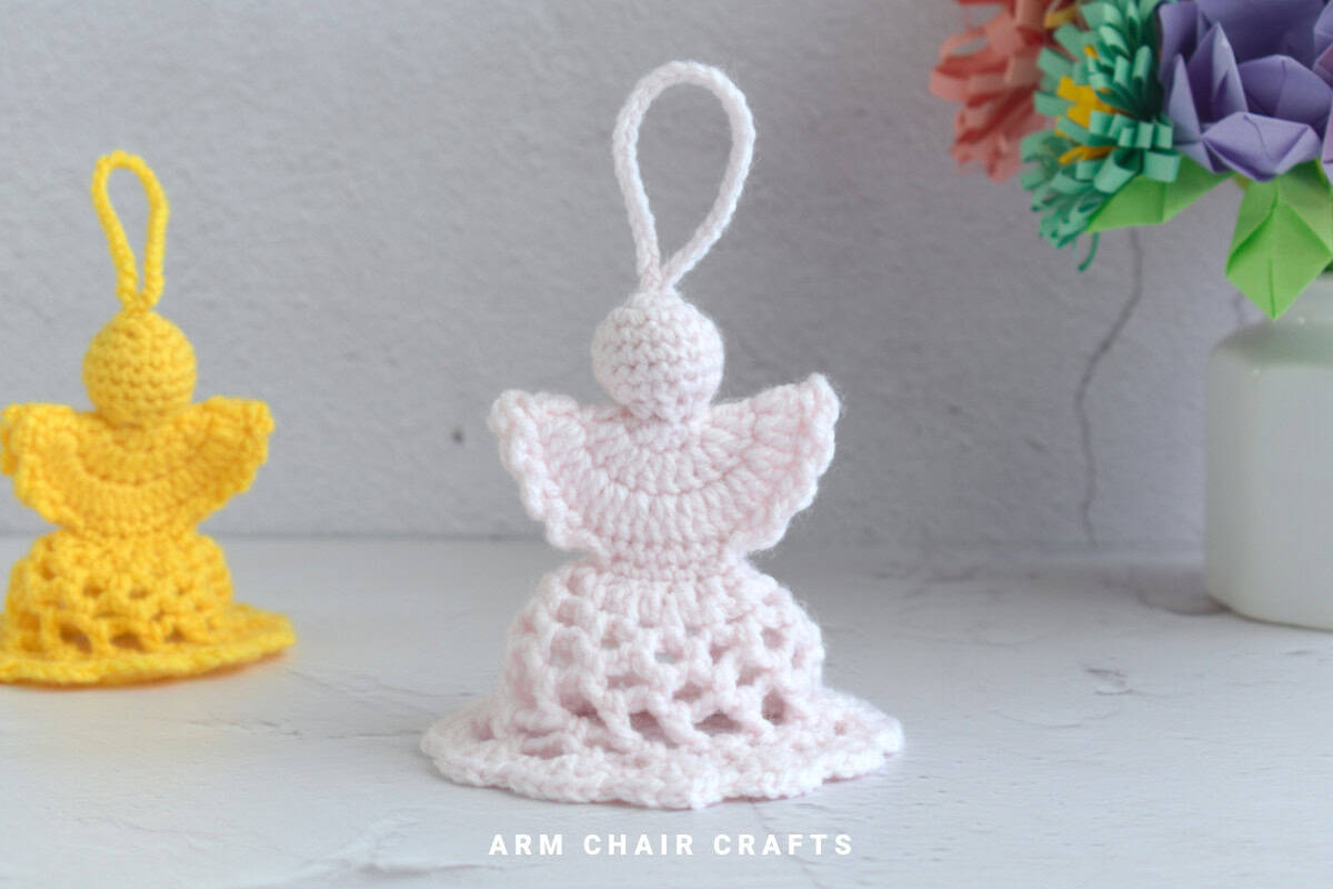 Close up image of a crochet angel ornament.