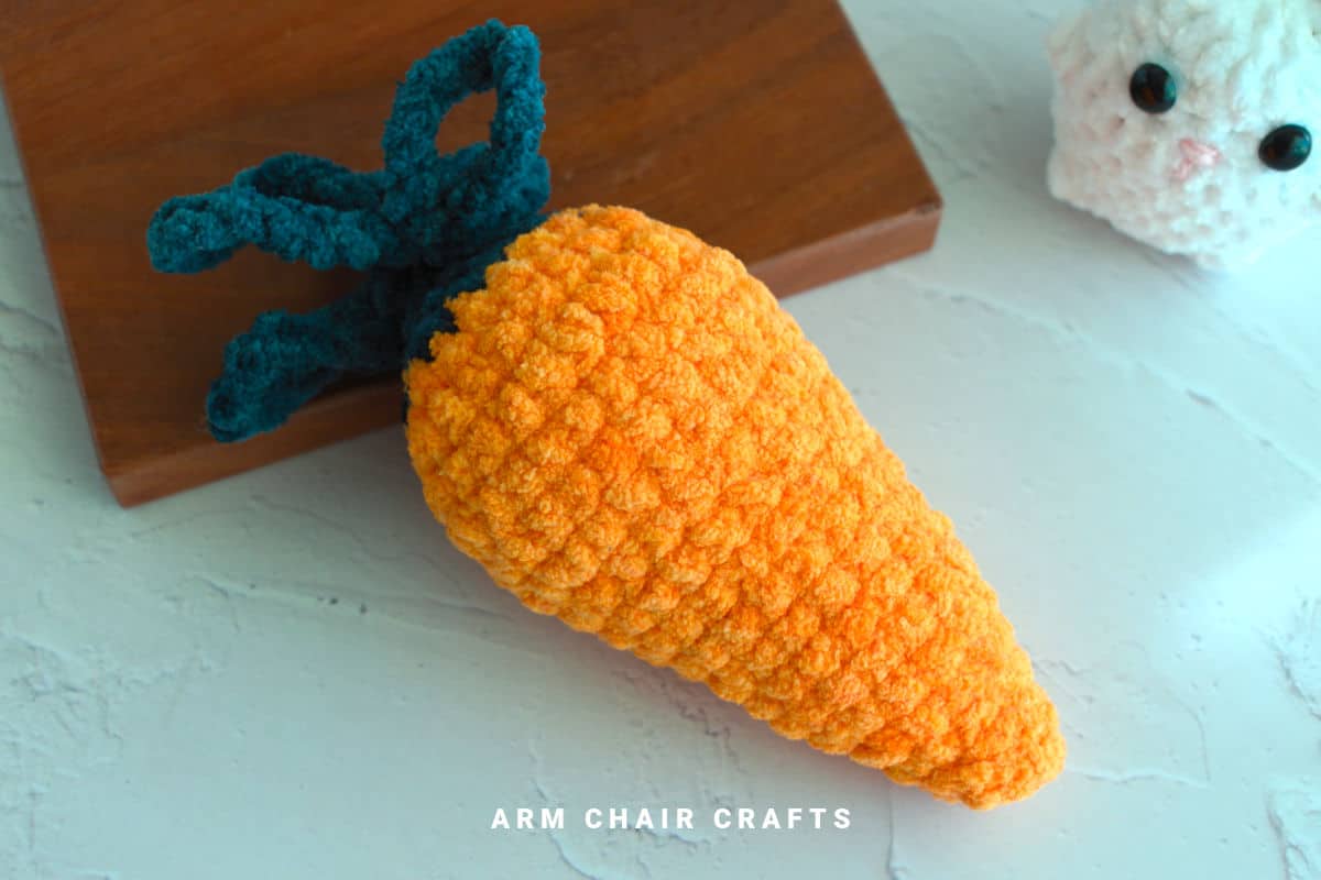Close up image of a crochet carrot.