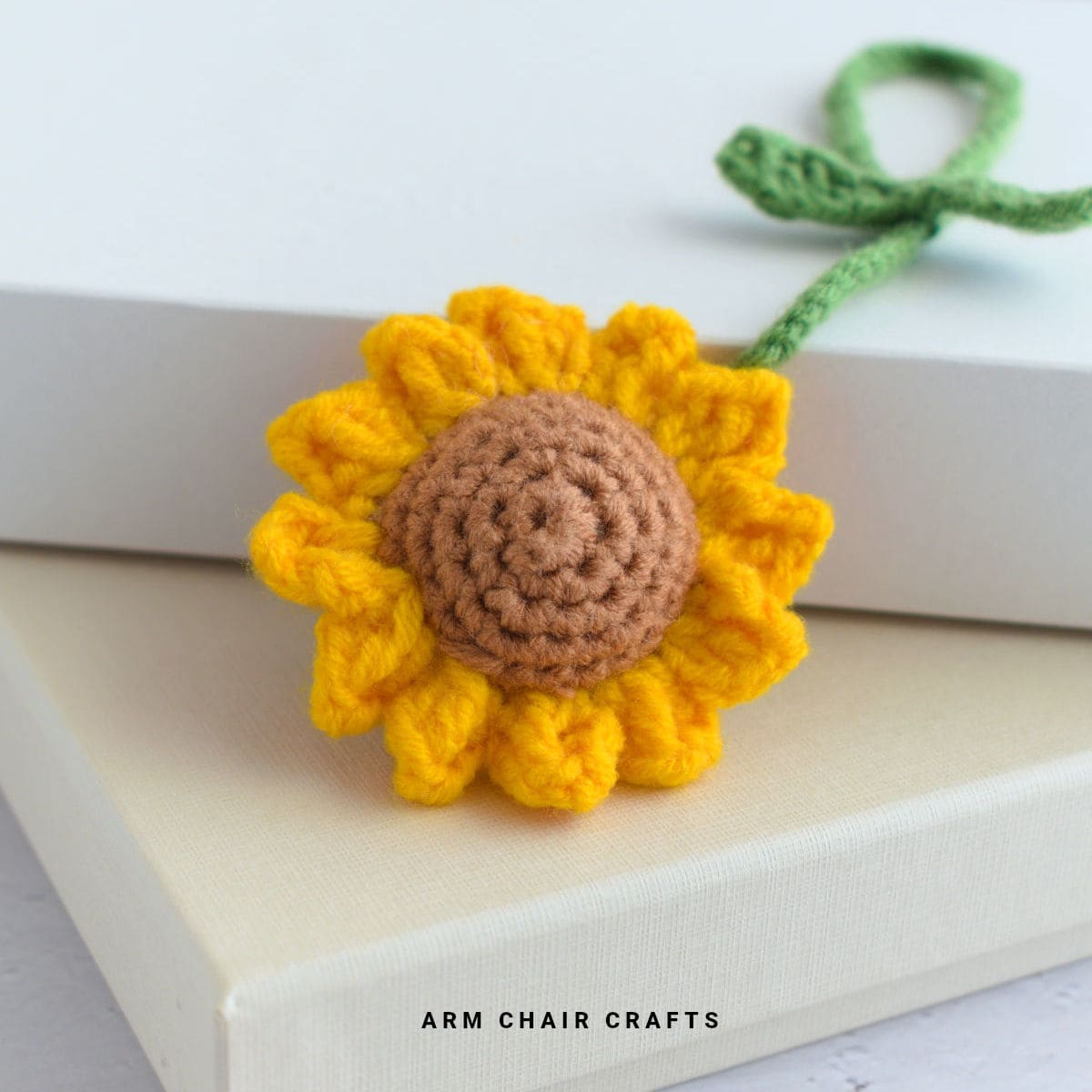 Close up image of a crochet sunflower hanging charm.