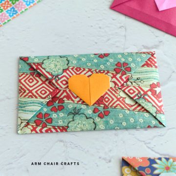 Origami envelope with an orange heart.