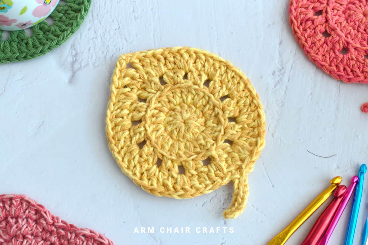 Yellow leaf crochet coaster.