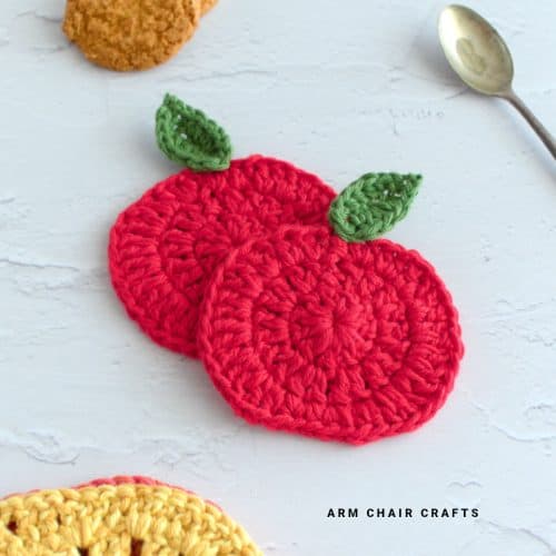 Close up image of apple crochet coasters.