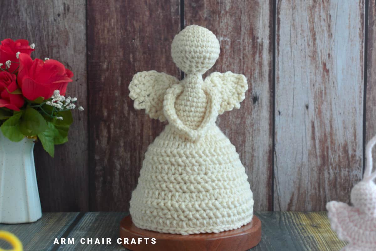 Close up image of a standing crochet angel.