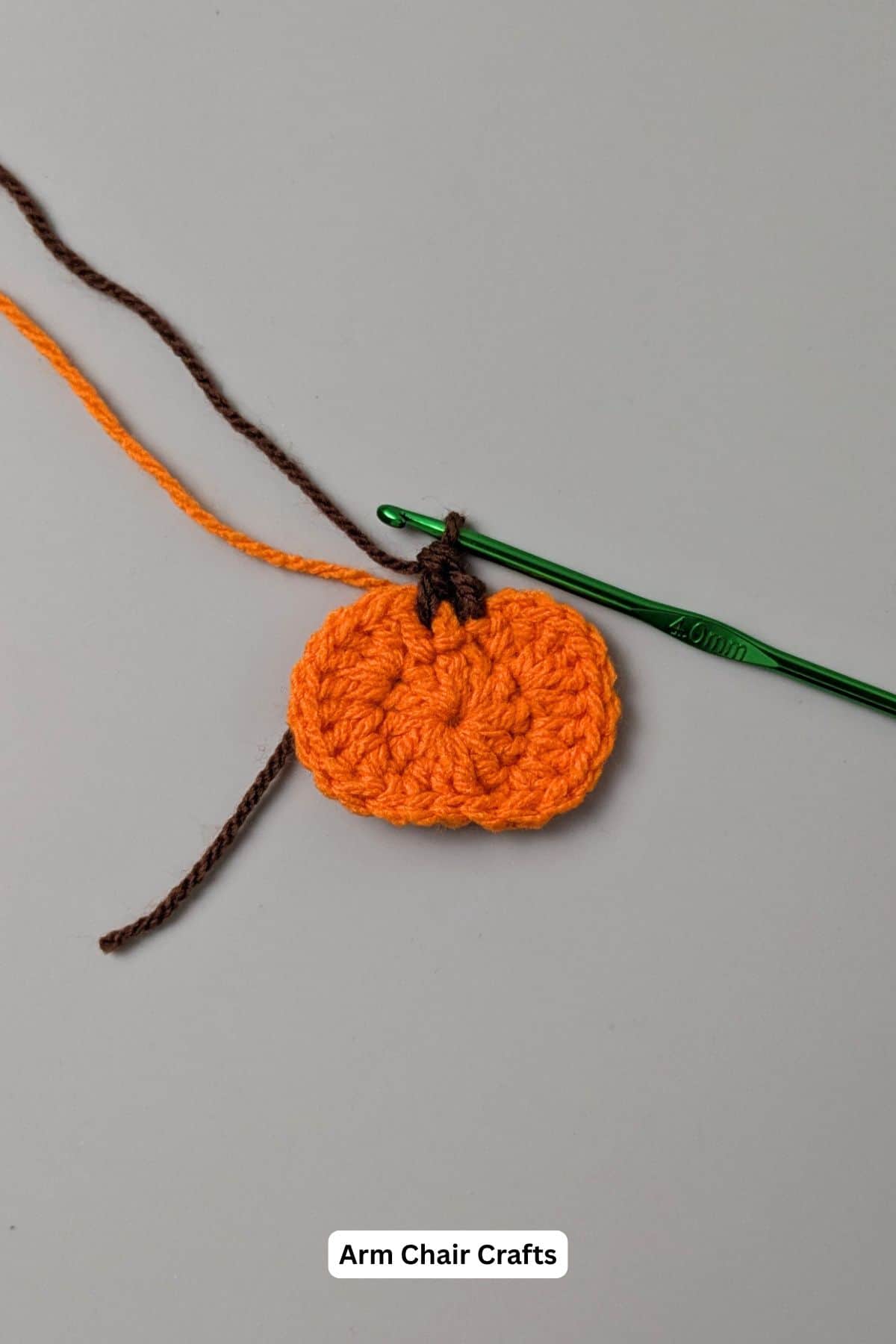 Making a crochet pumpkin motif.