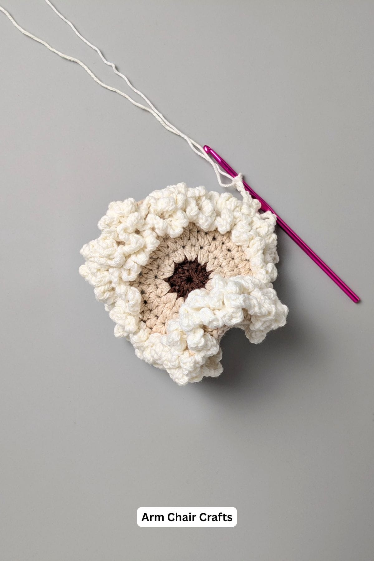 Curled sheep crochet coaster.