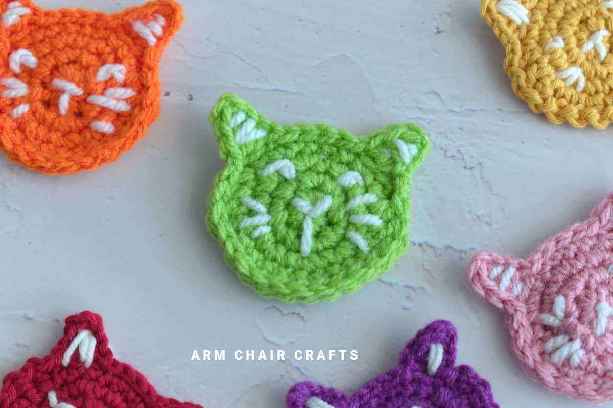 Close up image of a crochet cat applique.