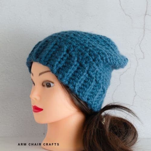 Close up image of a blue crochet beanie.