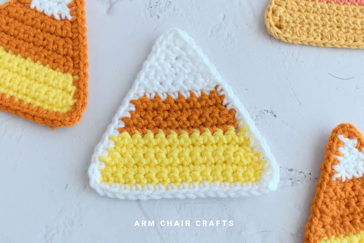 Close up image of a candy corn coaster.
