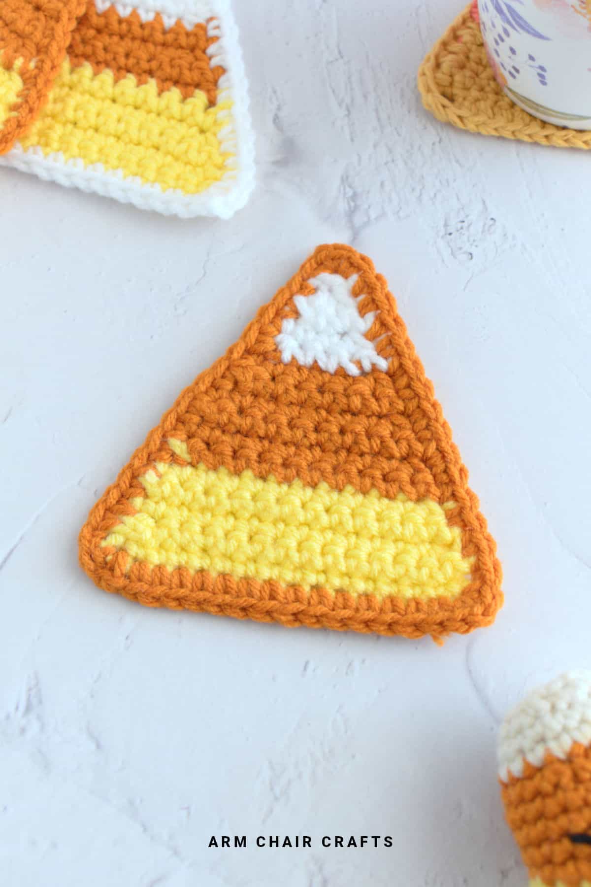 Crochet candy corn coaster.